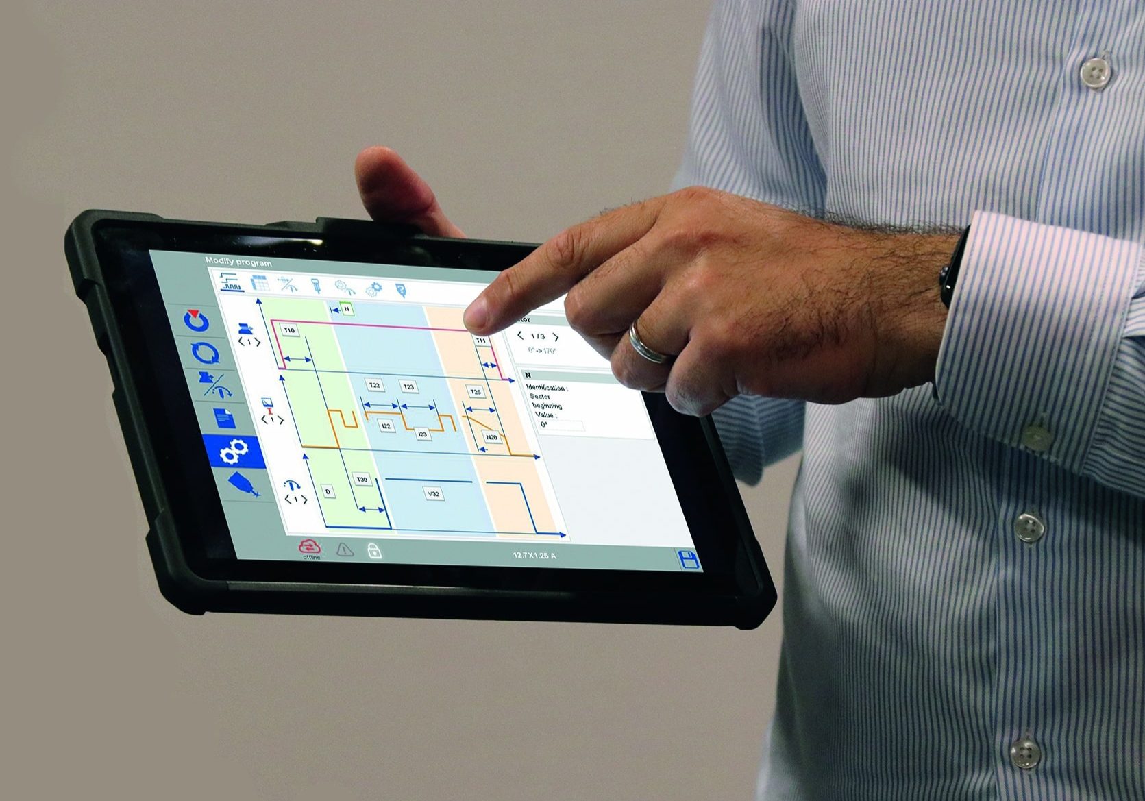 Operator using the P3 UHP Smart Welding Station wireless tourchscreen controller programing the TIG welding parameters